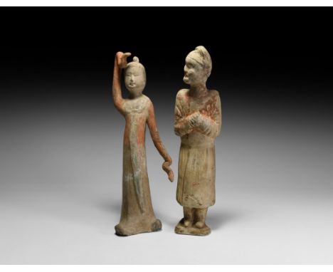 Tang Dynasty, 618-906 AD. A group of ceramic figures comprising: one standing female dancer, one arm raised above her head, t