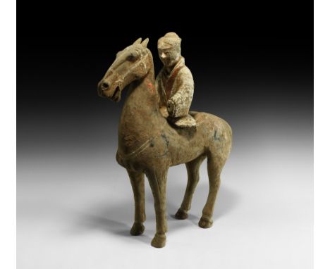 Han Dynasty, 206 BC-220 AD. An unglazed ceramic figure formed as a standing horse with detachable female rider; rider with dr