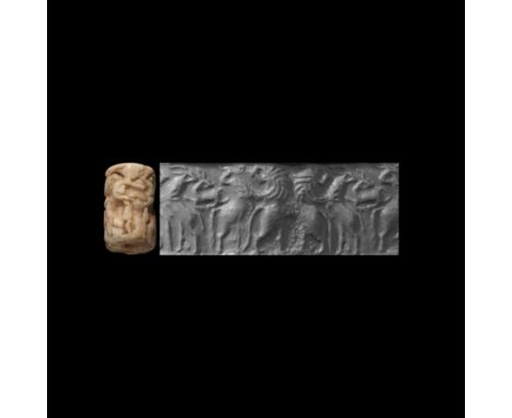 Early Dynastic III, 2500-2400 BC. A white marble cylinder seal with a contest scene, accompanied by a museum-quality impressi