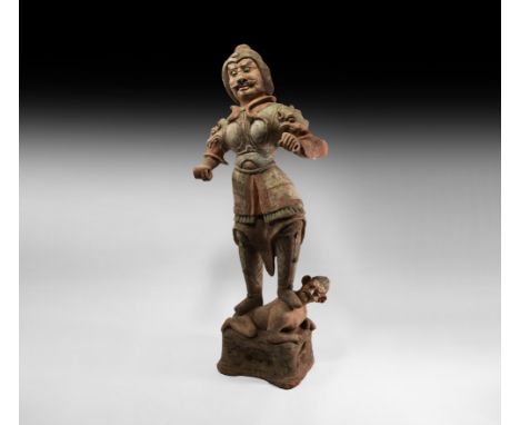 Tang Dynasty, 618-906 AD. A ceramic figure formed as a victorious guardian standing on the back of a struggling grotesque fig