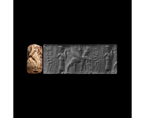 2300-2000 BC. A jasper cylinder seal with a worshipper before a cuneiform inscription, monster behind; accompanied by a museu