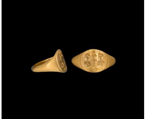 8th-10th century AD. A gold ring with D-section hoop, expanding shoulders and oval-shaped bezel with incuse design comprising