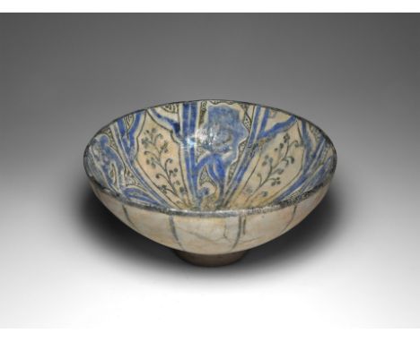 12th-14th century AD. A ceramic bowl with hemispherical body and deep pedestal foot; interior with triangular panels radiatin