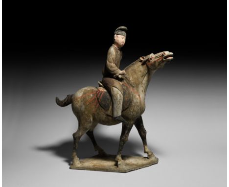 Tang Dynasty, 618-906 AD. A finely modelled hollow-formed ceramic figurine of a horse and rider; the horse standing on a rect