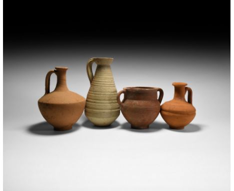 1st-3rd century AD. A mixed group of four ceramic vessels, comprising: a piriform vessel with shallow foot, broad neck and fl