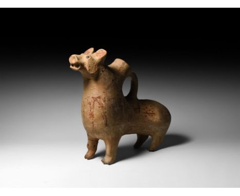 14th-4th century BC. A ceramic vessel formed as a standing 'tiger', tail curled around one side of body, with erect ears, ale
