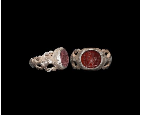 3rd century AD. A copper-alloy ring with carinated, openwork hoop with scrolls, expanding at the shoulders to an oval-shaped 