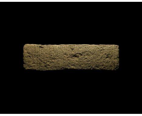 20th-17th century BC. A rectangular ceramic block with low-relief cuneiform text to one long face; accompanied by an old scho
