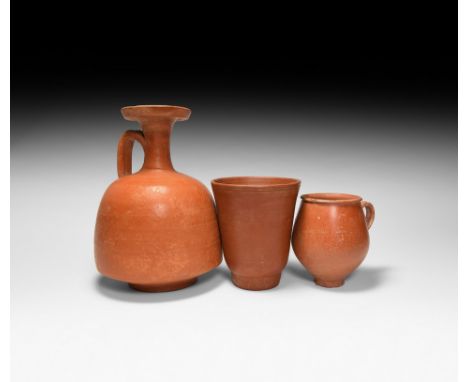 1st-3rd century AD. A mixed group of three ceramic redware vessels comprising: one candle holder(?) with carinated body, cott