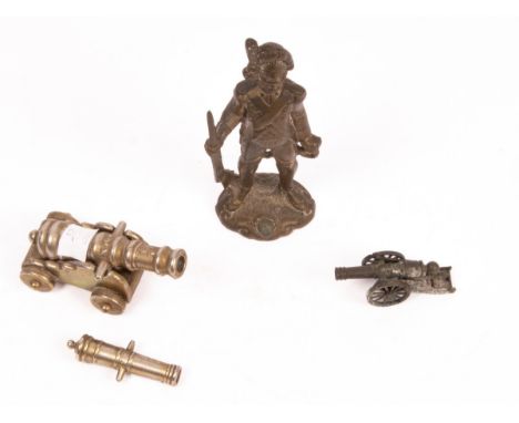 A gilt metal figure of a soldier, 16.5cm high and three small model cannons CONDITION REPORT: Condition information is not us