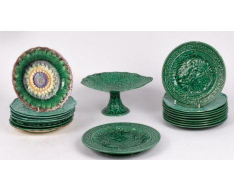 A collection of nineteen green-glazed pottery plates, late 19th Century, moulded with various fruit/flower designs and two co