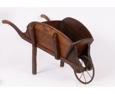A Victorian oak wheelbarrow with metal front wheel, 92cm long x 44cm wide x 43cm high   CONDITION REPORT:  Child's Wheelbarro