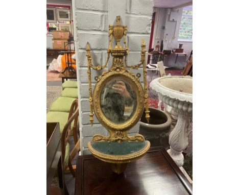 A gilt wall bracket with oval mirror back CONDITION REPORT: Condition information is not usually provided in the description 