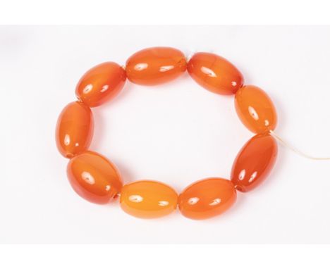 An orange agate bead bracelet of nine oval beads, a gold opal and diamond stick pin, approximately 2.5g and a gold coloured k