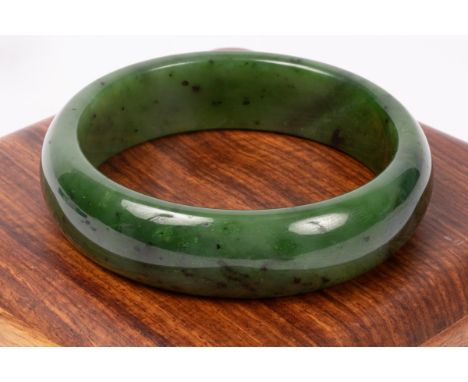 A jade bangle, 63mm inner diameter, approximately 81.4g, in fitted wooden box  CONDITION REPORT: Condition information is not