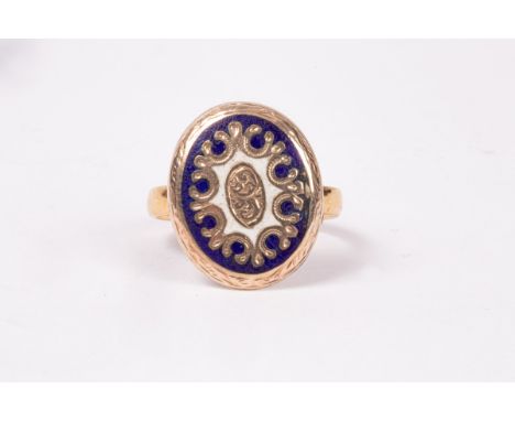An oval gold coloured and enamel mount on a 22ct gold band, approximately 3g and an 18ct gold and diamond solitaire ring, app