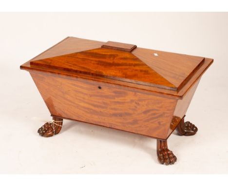A mahogany cellarette, stamped Wilkinson Ludgate Hill, early 19th Century, sarcophagus shaped, on lion paw feet, fitted with 