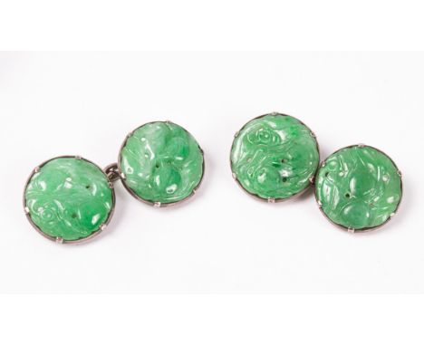 A pair of carved jade cufflinks, the circular links set in white metal, boxed by WAT de Silva, Kandy, Ceylon    CONDITION REP