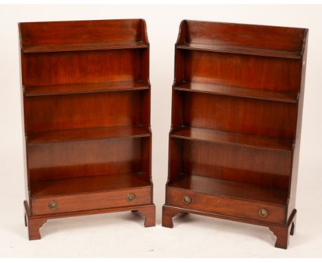 A pair of mahogany waterfall front open bookcases, each fitted a drawer and on bracket feet, 64.5cm wide x 23cm deep x 107cm 