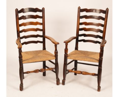 A pair of ash framed ladder back chairs with rush seats CONDITION REPORT: Condition information is not usually provided in th