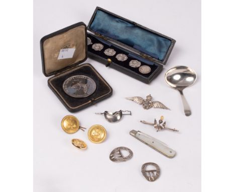 A set of four early 20th Century silver buttons, cased, a silver caddy spoon, a RAF badge, a par of silver buckles etc.  COND