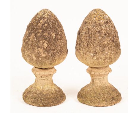 A pair of reconstituted stone pineapple gate post finials, 52cm high CONDITION REPORT: Condition information is not usually p