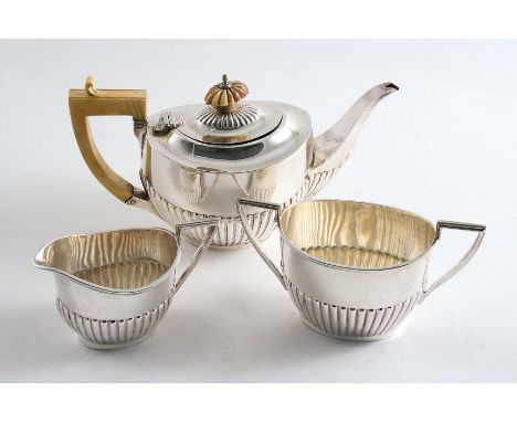 AN EDWARDIAN SMALL TEA POT with part-fluted decoration, an ivory handle & finial, maker's mark unclear, Birmingham 1909 and a
