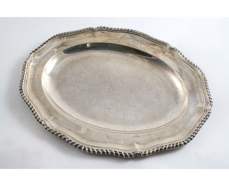 A VICTORIAN SMALL MEAT DISH of shaped oval outline with a gadrooned border & engraved coat of arms of a Baron on one side, by