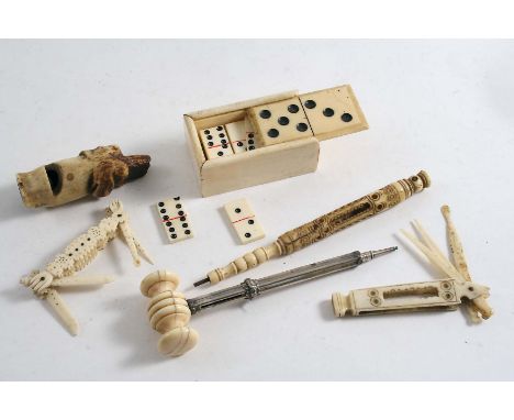 A MIXED LOT:- A set of 19th century miniature bone dominoes in a box with a sliding cover, a carved bone hound mask whistle, 