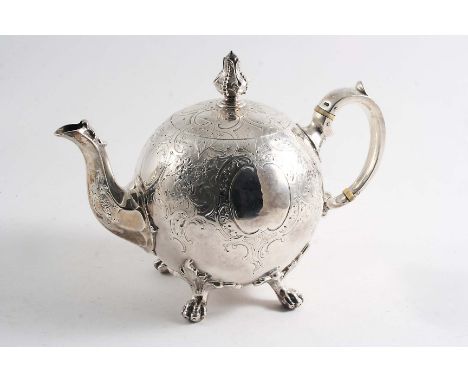 A VICTORIAN BULLET TEA POT on four paw feet with a bud finial, chased decoration over the upper body and cover and a vacant c