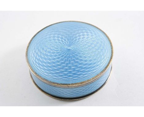 AN EARLY 20TH CENTURY NORWEGIAN SILVERGILT CIRCULAR BOX decorated with translucent light blue enamel over an engine-turned gr