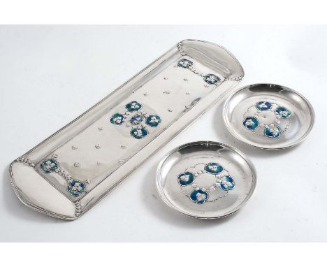 AN EDWARDIAN ART NOUVEAU SMALL DRESSING TABLE TRAY & TWO MATCHING PIN DISHES, each decorated with enamel and stamped florets,