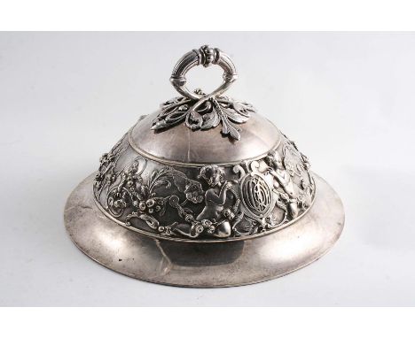 A VICTORIAN DOMED CIRCULAR DISH COVER with a detachable openwork handle and a cast frieze of putti, scrolls and floral garlan