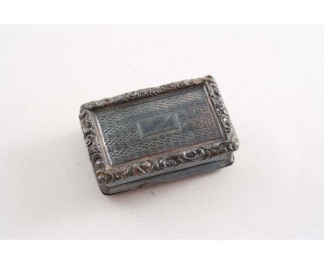 A WILLIAM IV ENGINE-TURNED VINAIGRETTE with a raised scroll border, reeded sides and a vacant oblong cartouche on the cover, 