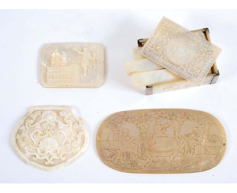 A GROUP OF CARVED MOTHER OF PEARL ITEMS including a box lid with figures smoking &amp; drinking; 13 x 6.5 cms, two snuff box 
