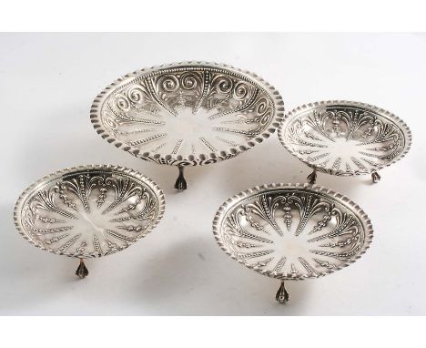 A LATE VICTORIAN SUITE OF ONE LARGE & THREE SMALLER CIRCULAR BONBON DISHES on ball & claw feet with crimped borders and punch