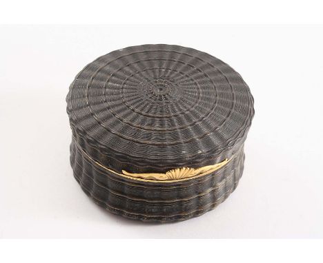 A LATE 18TH CENTURY GOLD-MOUNTED TORTOISESHELL SNUFF BOX circular moulded decoration to resemble engine-turning, with a shell