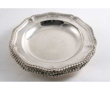 A SET OF FIVE VICTORIAN SOUP PLATES of shaped circular outline with gadrooned borders and the engraved coat of arms of an Ear
