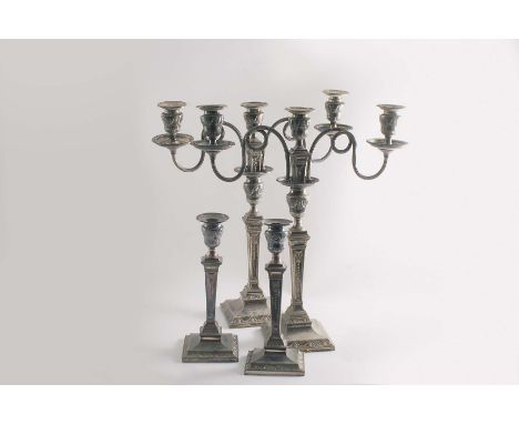 A PAIR OF LATE VICTORIAN ELECTROPLATED THREE-LIGHT CANDELABRA on bevelled square bases with embossed borders of floral garlan