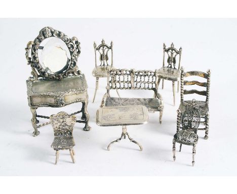 MINIATURE SILVER FURNITURE comprising a dressing table, settee, tripod table and five occasional chairs, Continental