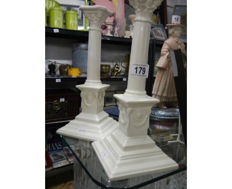 A pair of white ceramic candlesticks.