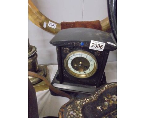 A black slate mantel clock.