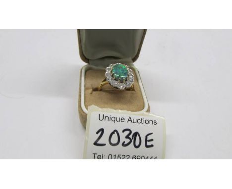 An 18ct gold opal and diamond ring, size M, total weight 6.8 grams. Stones in very good condition