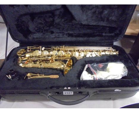 A cased Stagg alto saxaphone (unused).