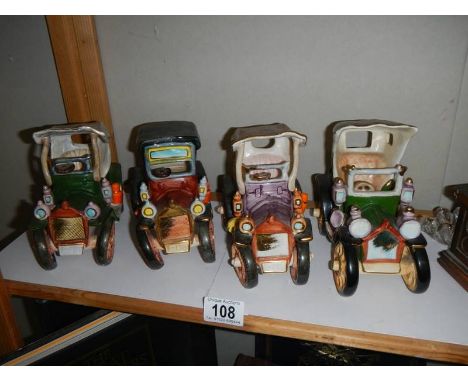 Four ceramic vintage cars.