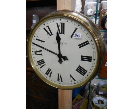 A brass faced Magneta Pulsynetic wall clock for use with a master clock.Diameter across face approximately 46cm