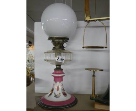 An early 20th century oil lamp on ceramic base with glass font, COLLECT ONLY.