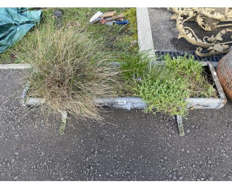 An old metal trough used as a planter