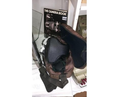A Praktika camera, accessories and 'The Camera Book'.