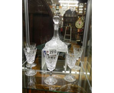 A small crystal ship's decanter and five glasses.